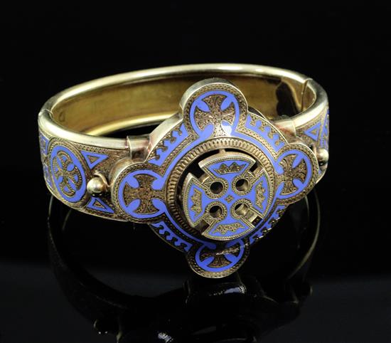 A Victorian gothic style gold and pale blue enamel hinged bangle,